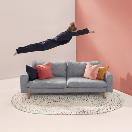 woman jumps onto sofa
