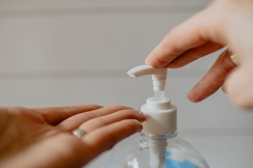 woman using hand sanitiser 