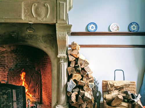 cozy fireplace and stack of wood