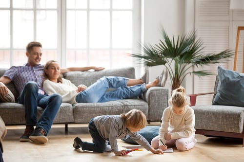 family relaxing together in Airbnb living room