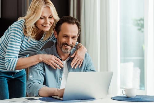 middle aged couple looking at laptop