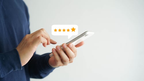 man leaves review using smartphone