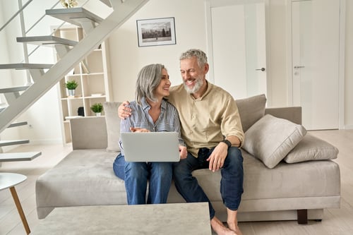 couple using laptop in their home