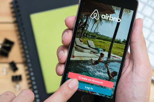 Apple iPhone with Airbnb application on the screen