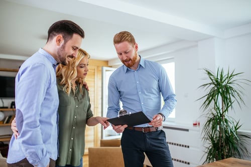 young couple consulting with property manager at home